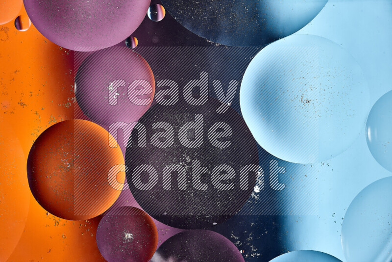 Close-ups of abstract oil bubbles on water surface in shades of blue, orange and purple