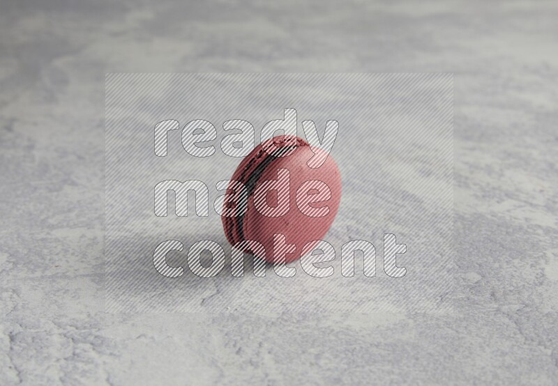 45º Shot of Red Cherry macaron on white  marble background