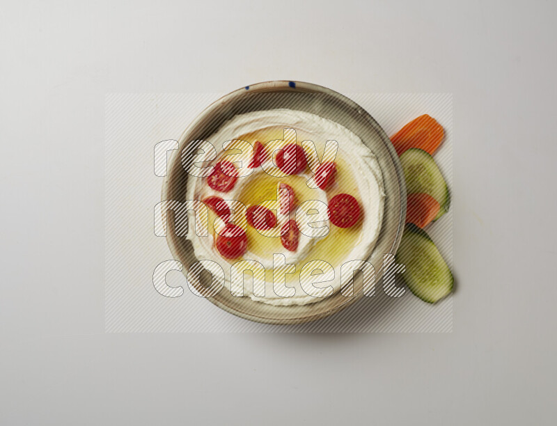 Lebnah garnished with cherry tomato in a grey pottery plate on a white background