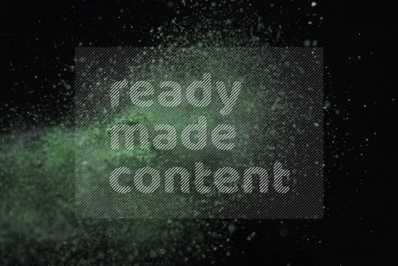 Green powder explosion on black background