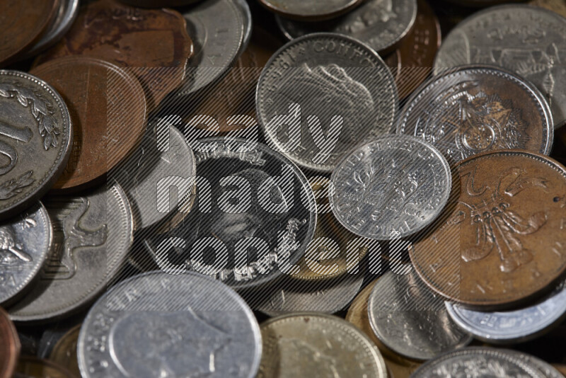 A close-ups of random old coins on black background