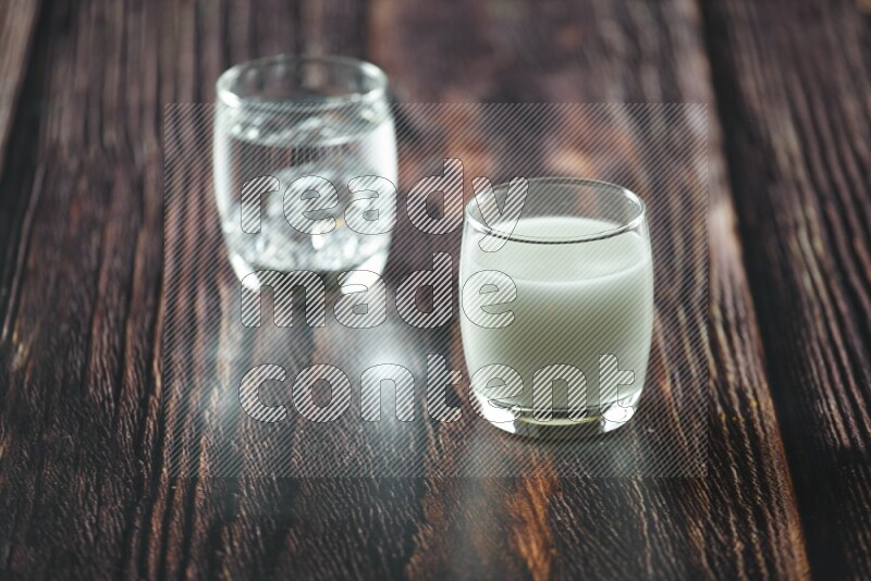 Cold drinks in a glass cup such as water, tamarind, qamar eldin, sobia, milk and hibiscus on wooden background