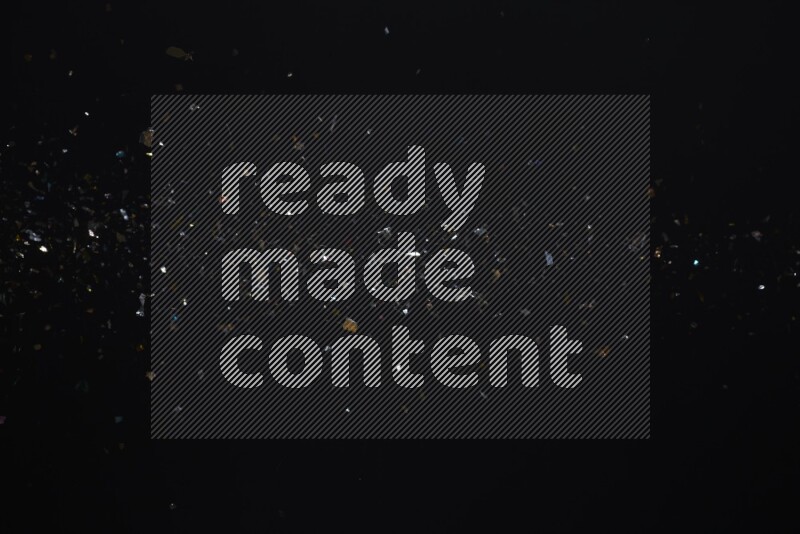 Falling multicolored confetti on black background