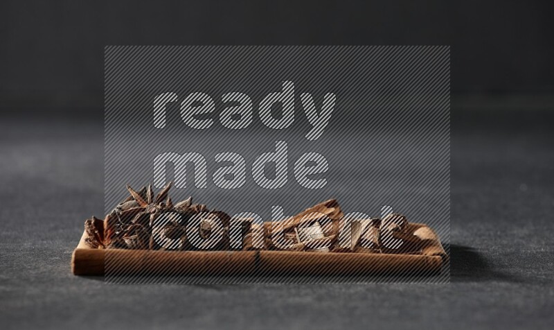 2 squares of cinnamon sticks full of star anise and cinnamon on black flooring