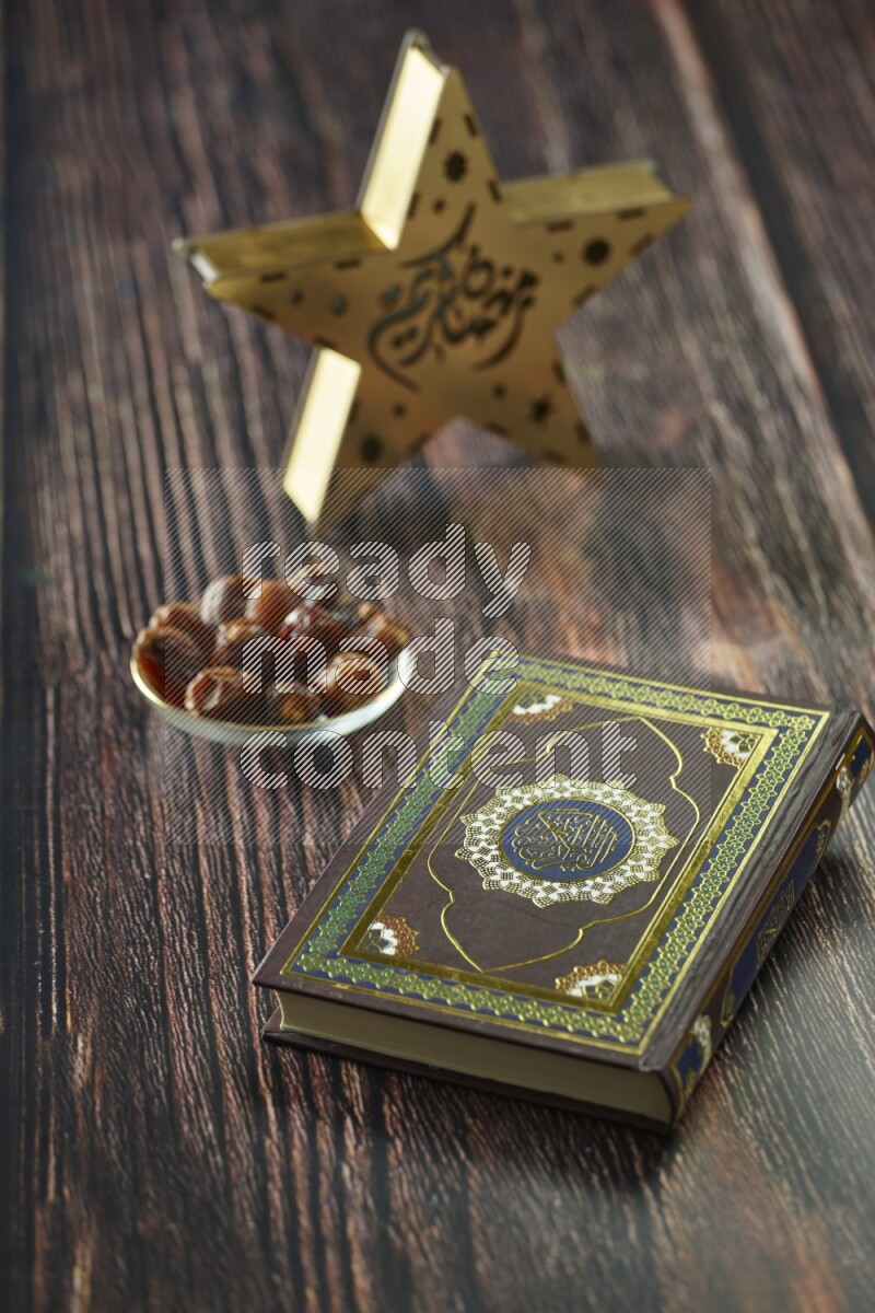 A wooden golden star lantern with different drinks, dates, nuts, prayer beads and quran on brown wooden background