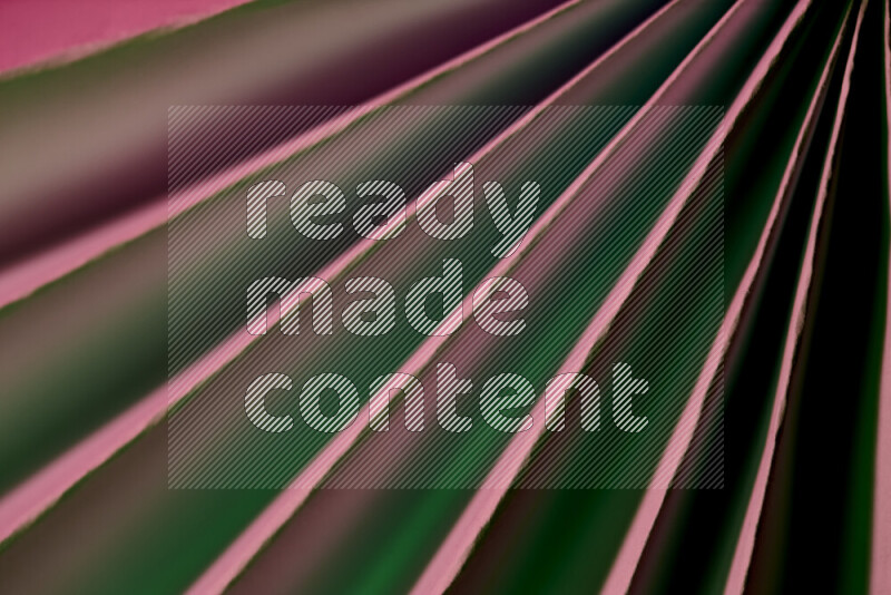 An image presenting an abstract paper pattern of lines in green and pink tones