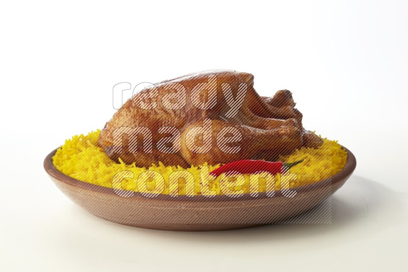yellow basmati Rice with whole roasted chicken  on a pottery plate  direct  on white background