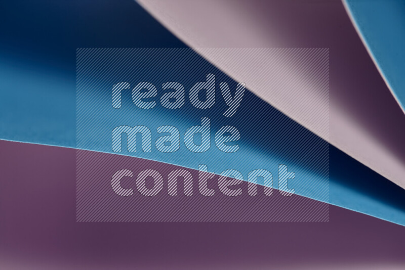An abstract art showing purple and blue paper sheets arranged in an overlapping curves