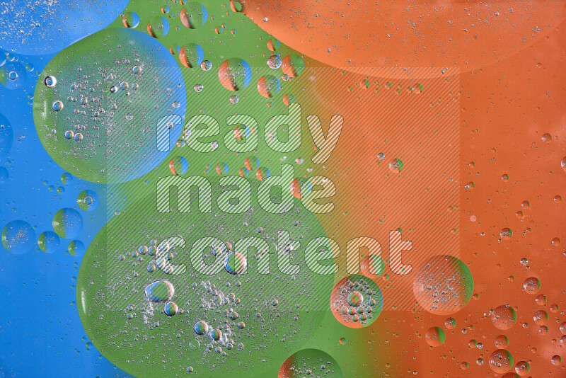 Close-ups of abstract oil bubbles on water surface in shades of orange, green and blue