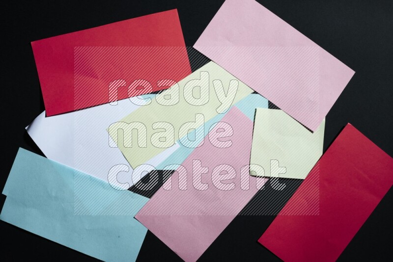 Multicolored paper sheet on black background