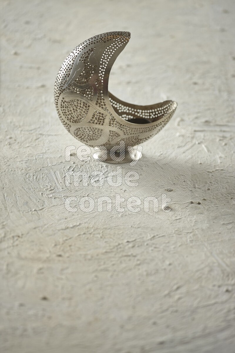 A lantern placed on a textured white background