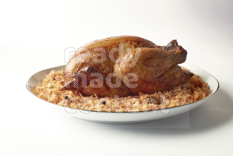 red basmati Rice with whole roasted chicken on a white plate with a silver rim direct on white background
