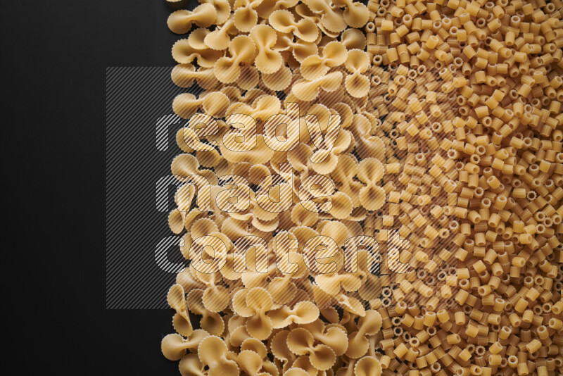 Different pasta types on black background