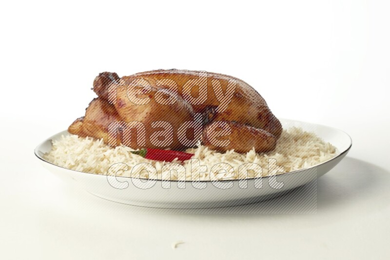 white  basmati Rice with  whole roasted chicken  on a white plate with a silver rim direct  on white background