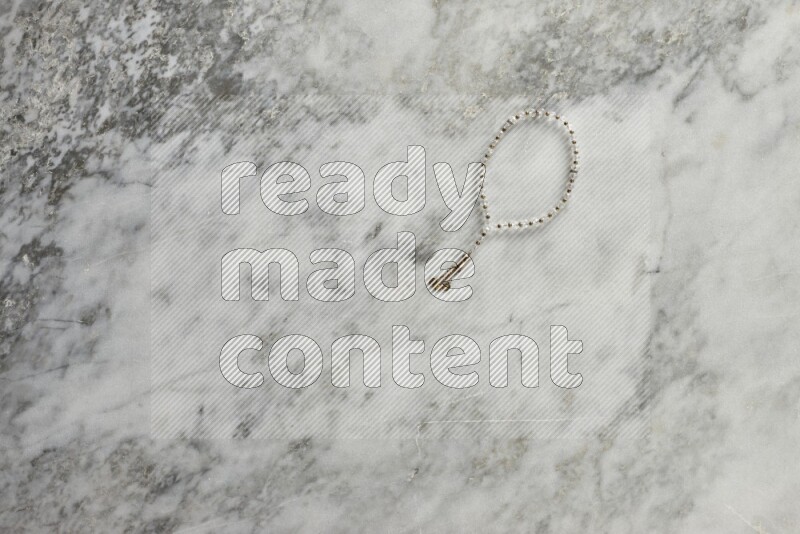 A prayer beads placed on grey marble background