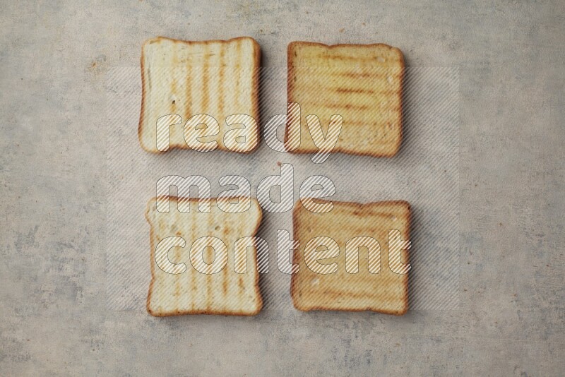 Toasted white Toast slices on a light blue textured background