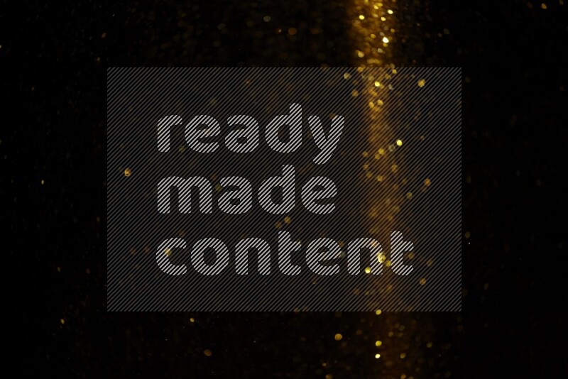Gold glitter powder isolated on black background