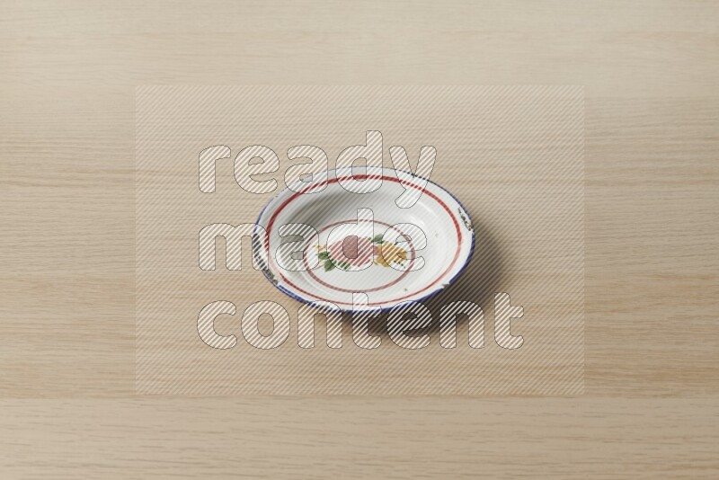 A vintage metal plate on light wooden background