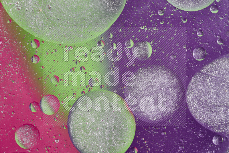 Close-ups of abstract oil bubbles on water surface in shades of purple, green and pink