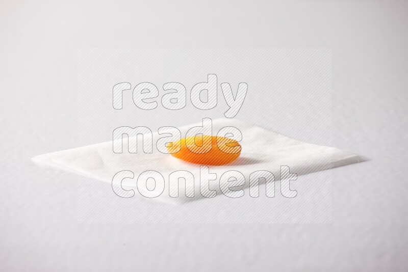 A dried apricot on a piece of paper on a white background in different angles