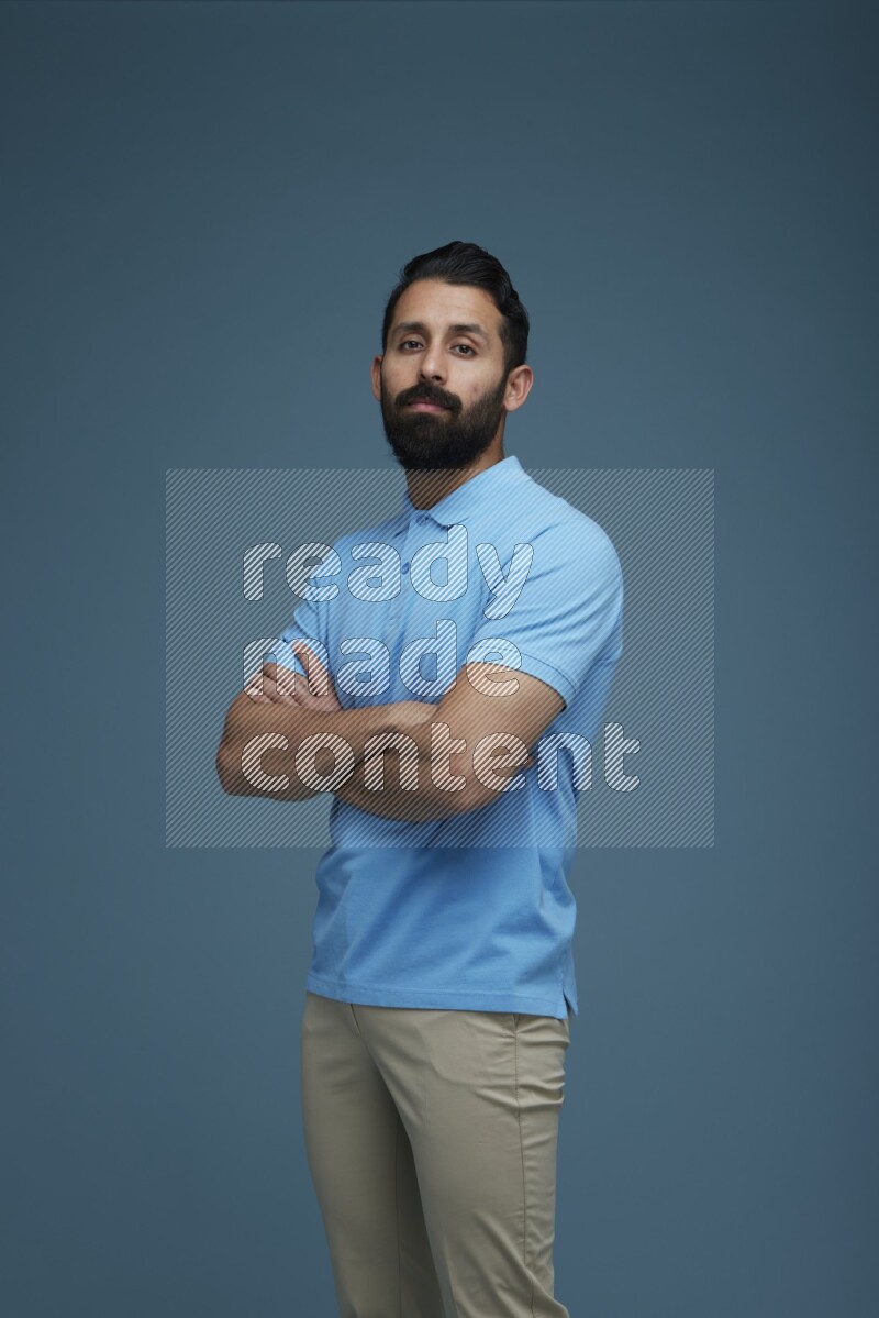 Man posing in a blue background wearing a Blue shirt