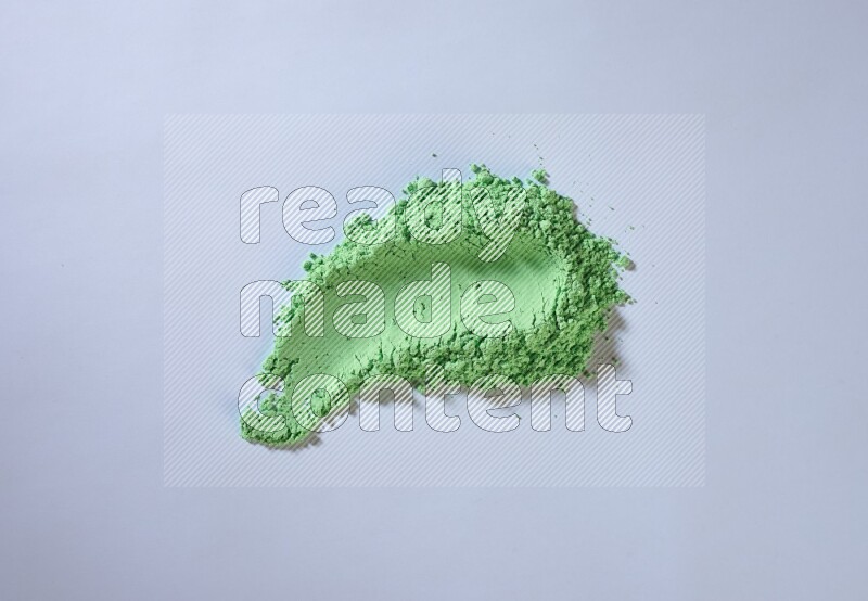 Green powder strokes on white background