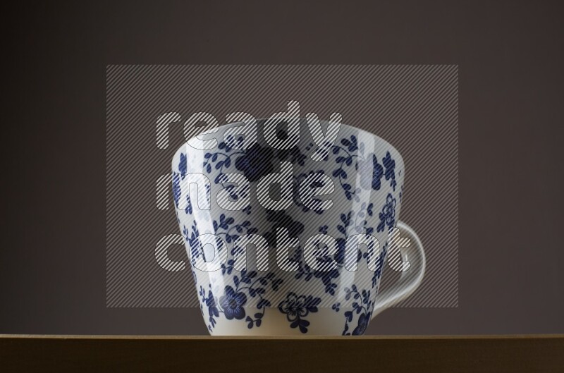 Low angle shot of a decorated cup on grey background