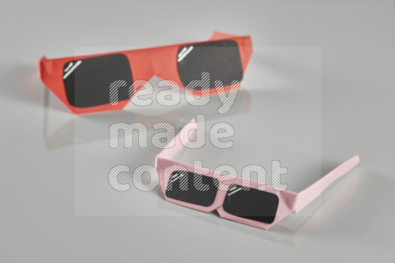 Origami sun glasses on grey background