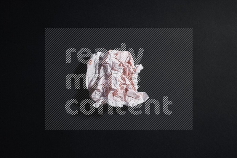 Crumpled notebook sheet on black background