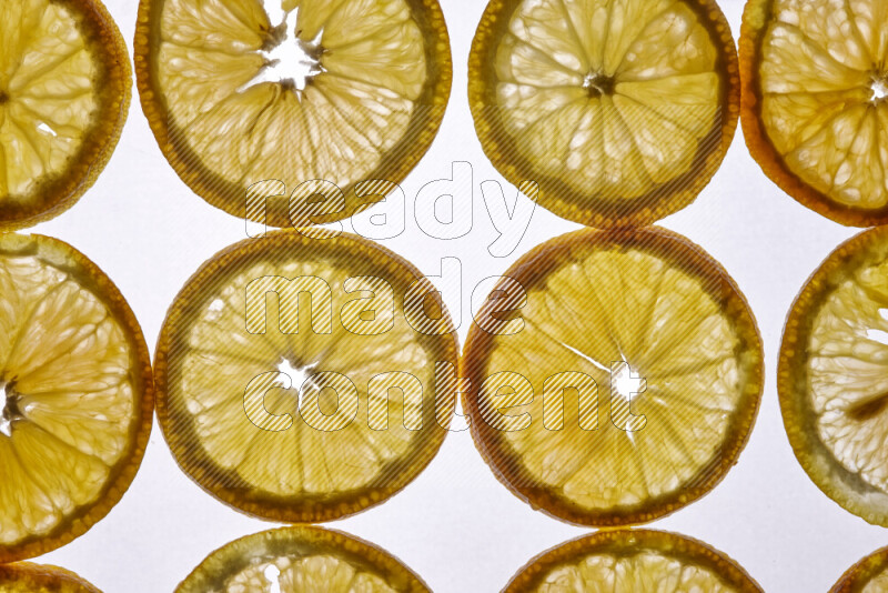 Orange slices on illuminated white background