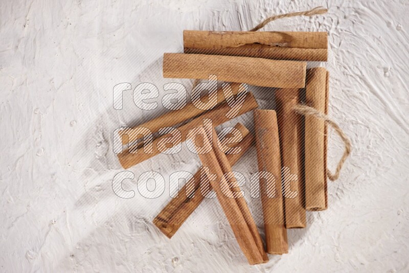 An unbounded stack of cinnamon sticks on white background
