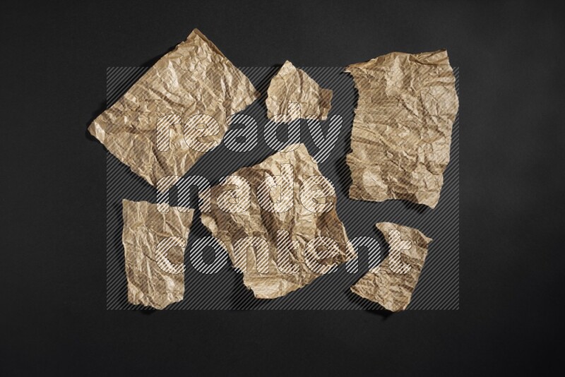 Crumpled craft paper on black background
