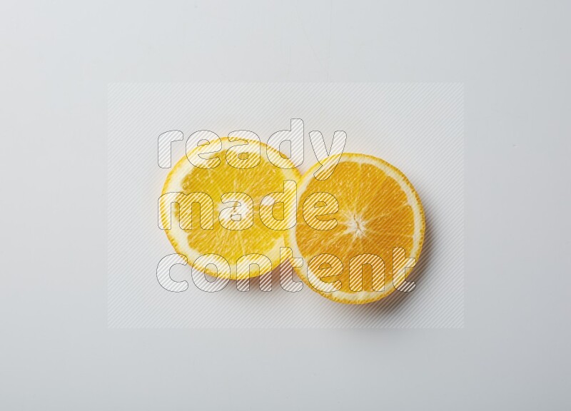 Two orange slices on white background