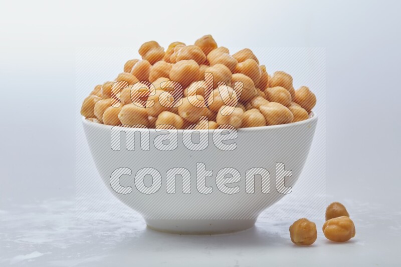 Close up of a boiled chickpeas in a container on white background
