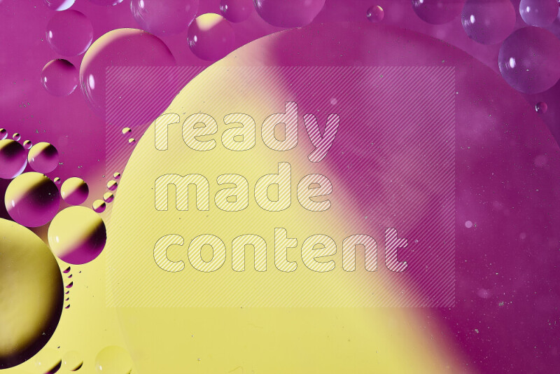 Close-ups of abstract oil bubbles on water surface in shades of yellow and pink