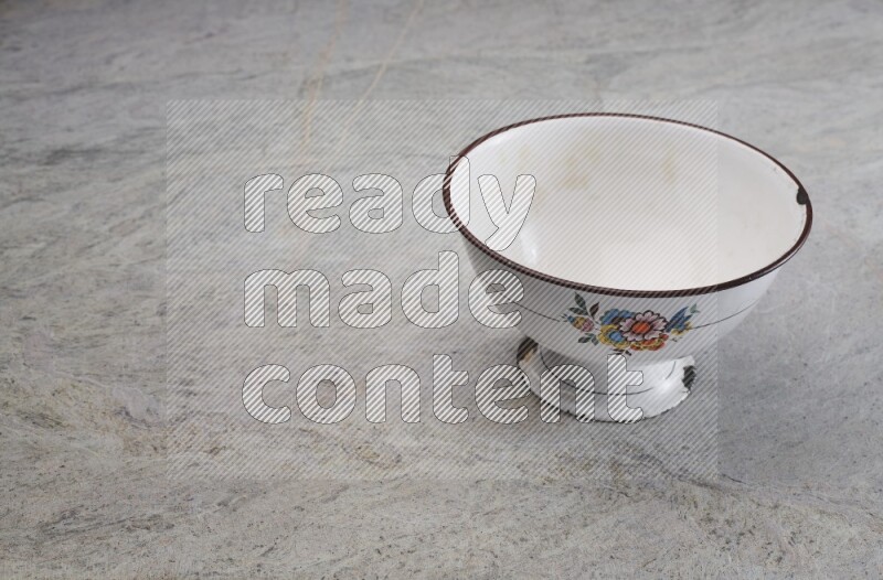 A vintage metal pot on grey marble background