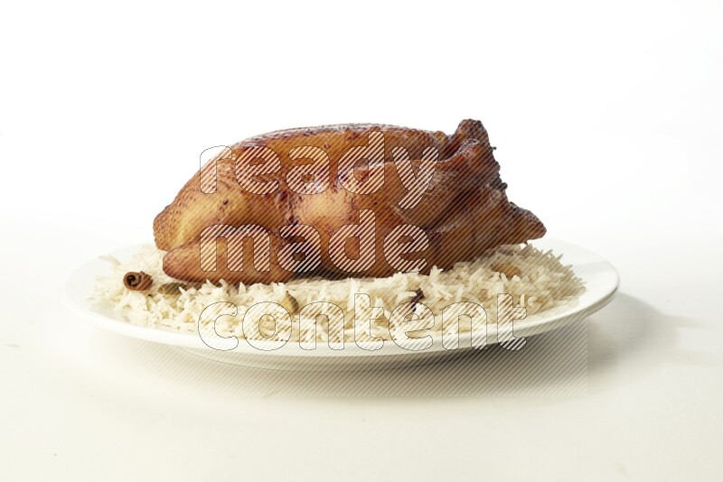 white  basmati Rice with  whole roasted chicken  on a white rounded plate direct on white background