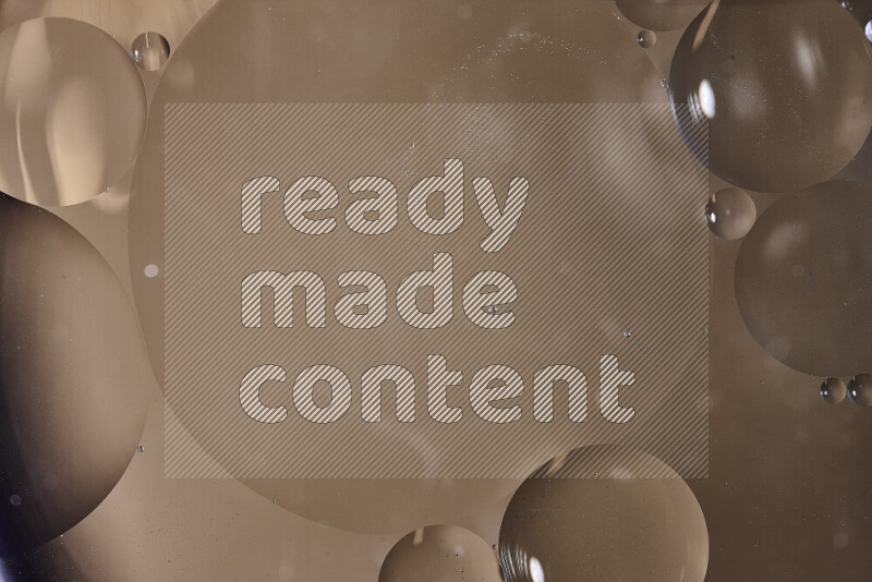 Close-ups of abstract oil bubbles on water surface in shades of brown