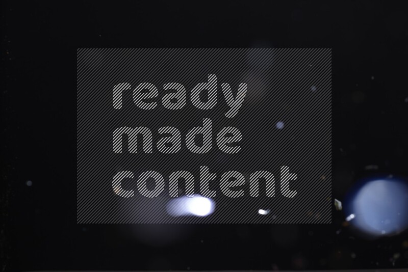 Falling multicolored confetti on black background