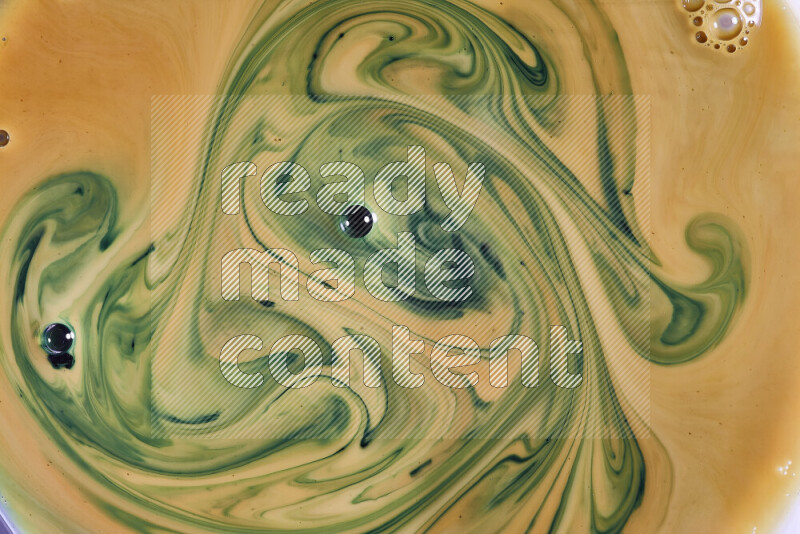 A close-up of abstract swirling patterns in orange and green