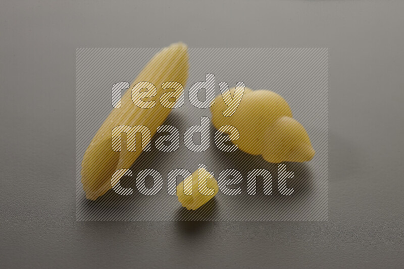 Different pasta types on grey background