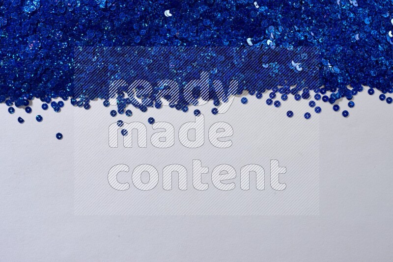 Multicolored flat sequins on grey background