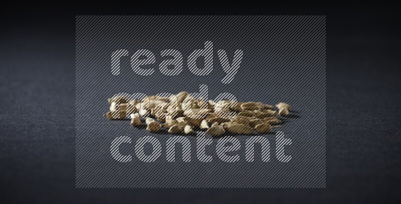 Cardamom seeds on black flooring