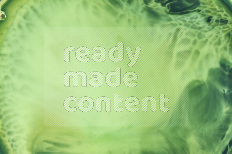 A close-up of abstract swirling patterns in green gradients