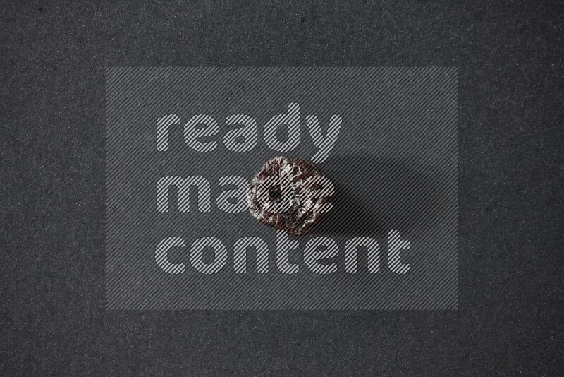 A dried plum on a black background in different angles