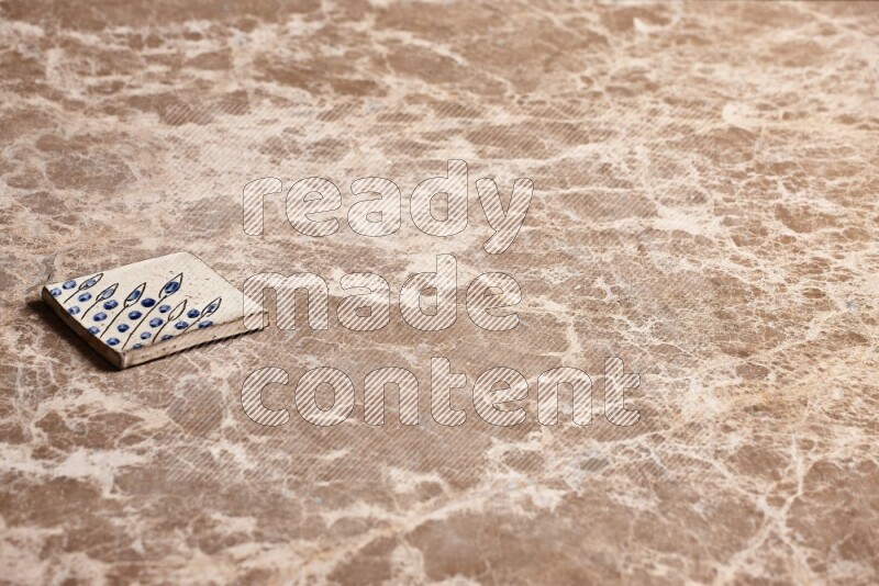 A decorative coaster on beige marble background