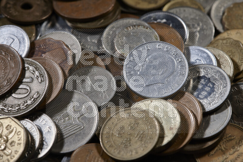 A close-ups of random old coins on black background