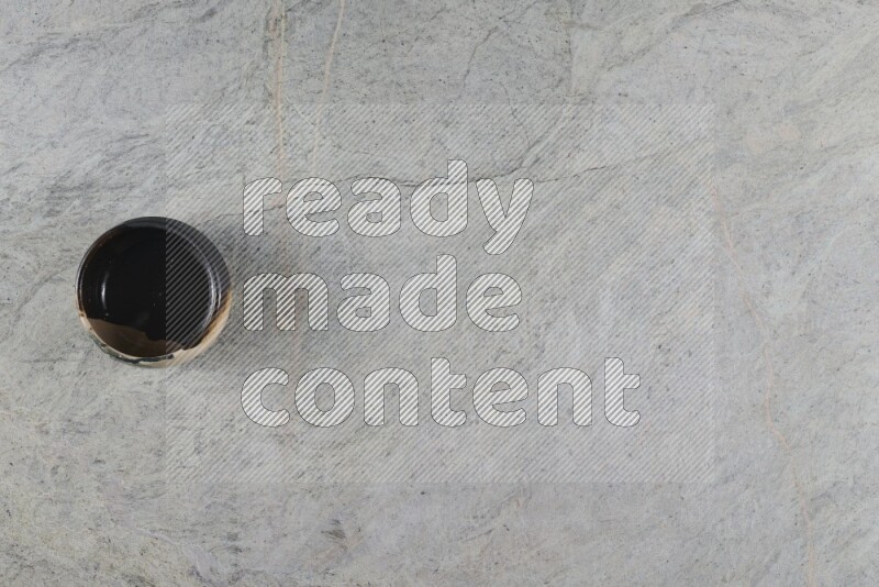 A multicolored pottery Bowl on grey marble background