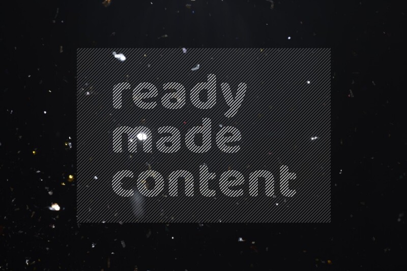 Falling multicolored confetti on black background