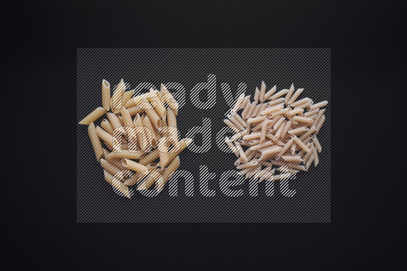Different pasta types in bunches on black background